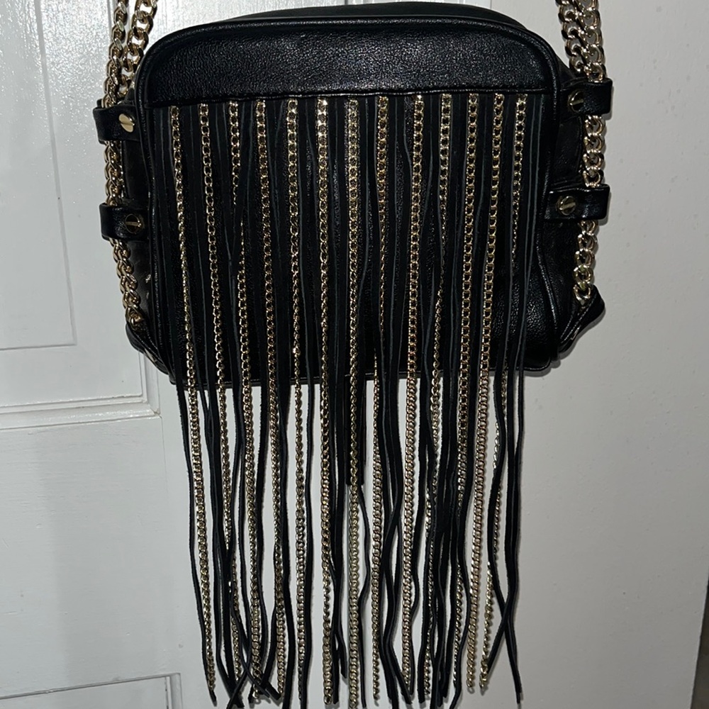Bebe black leather with a Gold and leather fringe back